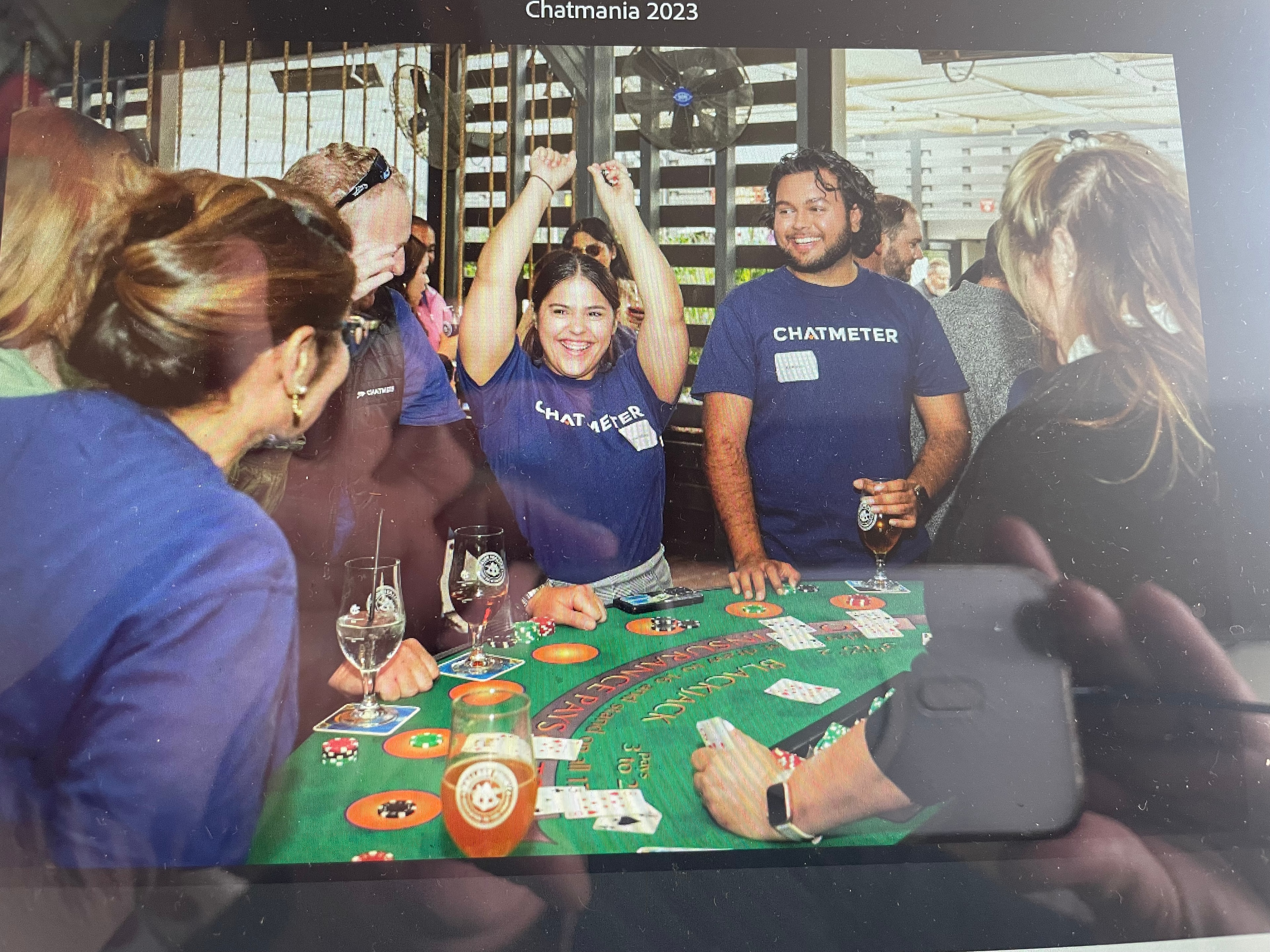 Chatmania 2023 corporate casino event guests celebrating at blackjack table