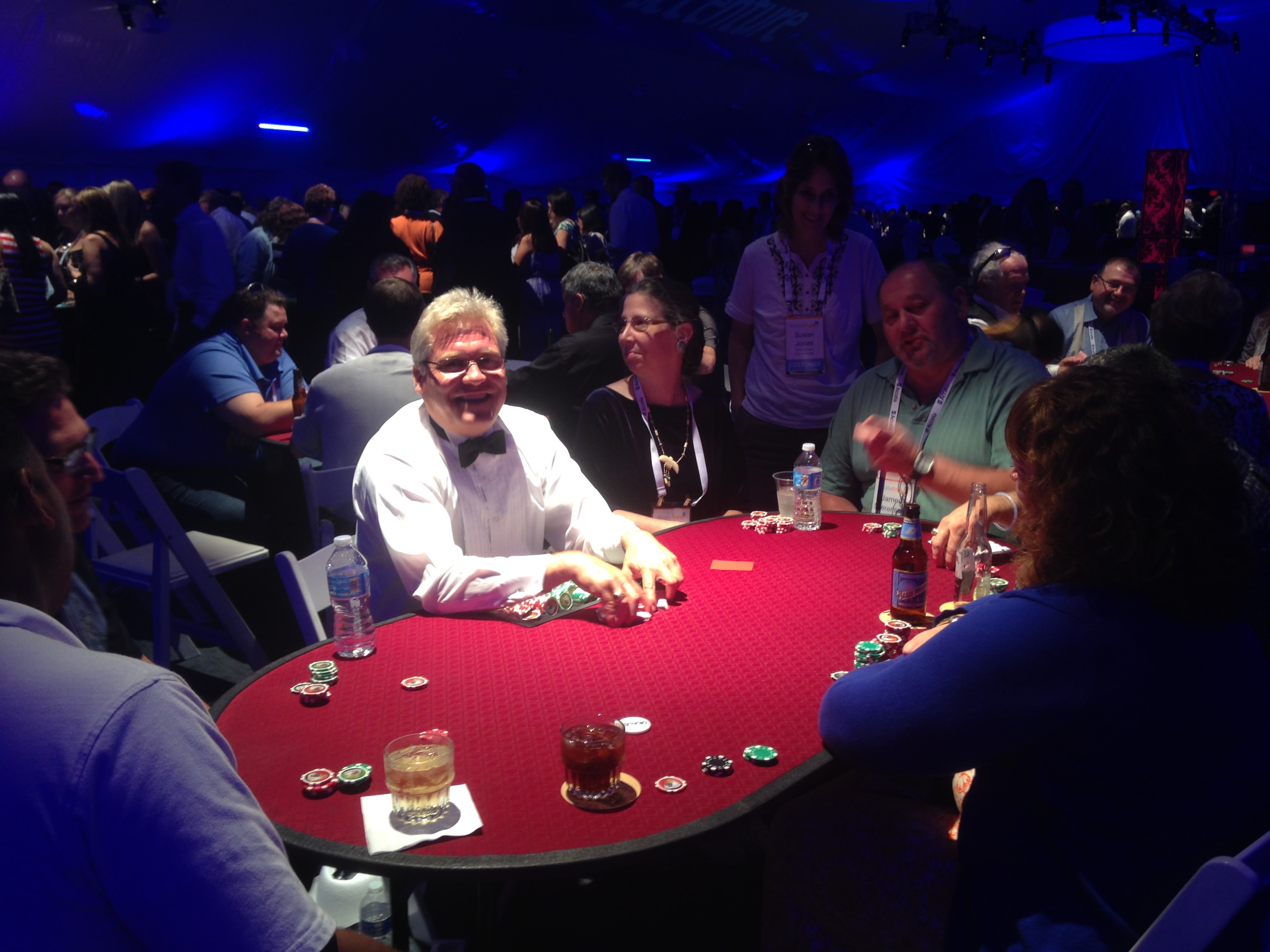 Guests playing Texas Hold 'Em poker at a casino party event