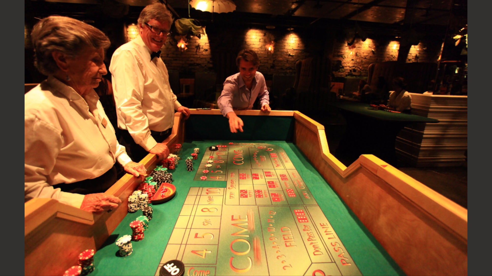 Craps table close-up with players