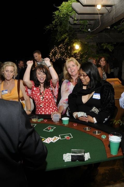 Guests cheering at an outdoor blackjack table