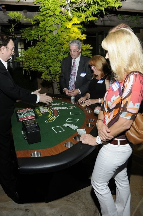 Dealer welcoming guests to blackjack table