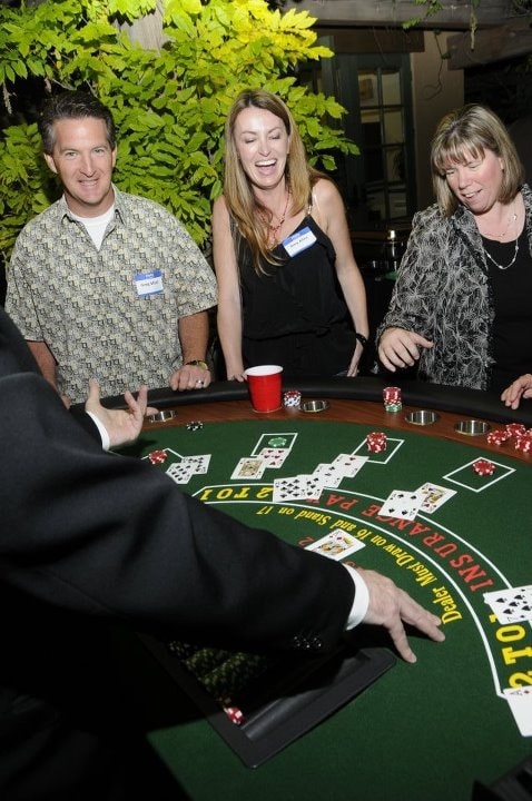 Guests laughing at outdoor blackjack table