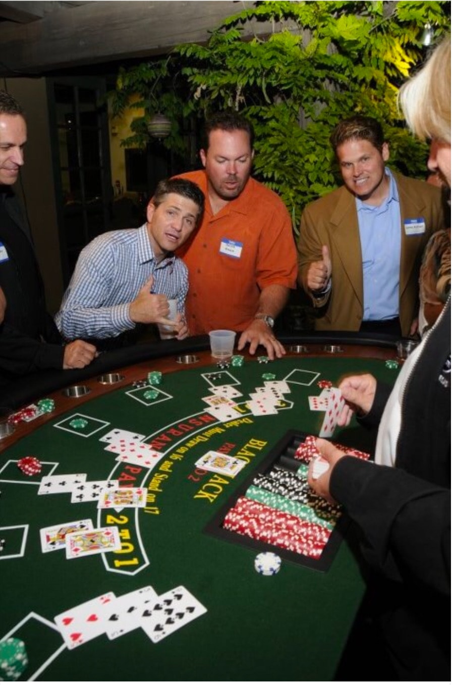 Guests giving thumbs up at outdoor blackjack