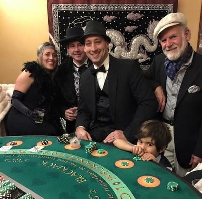 Casino dealers and guests enjoying a casino night event